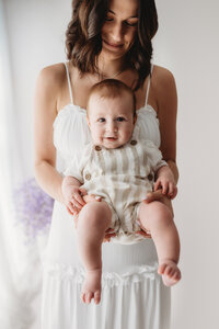 Charleston Mini Sessions - Mother embraces her baby during Mother's Day Mini Session at Holy City Babies in Charleston, SC.