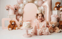Charleston Cake Smash Photographer -- Baby celebrates her first birthday with a Cake Smash Photoshoot at Holy City Babies Portrait Studio in Charleston, SC.
