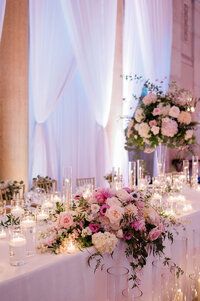 Several pink bouquets on sit on a W