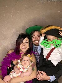Family of 4 in Photo booth wearing props