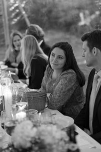 Wedding guests chat together over candle light.