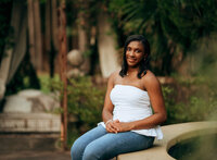 Senior portrait at Bella Sera Gardens in Loxley, Alabama — entering the courtyard beneath an
archway.
