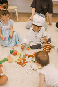 Little kids playing with fake food during their culinary class at The Bunny Hive