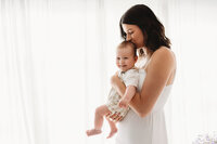 Charleston Mini Sessions - Mother embraces her baby during Mother's Day Mini Session at Holy City Babies in Charleston, SC.