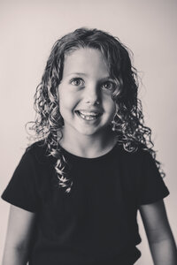 Young girl smiles at the camera during Personality Photoshoot in Charleston, South Carolina.