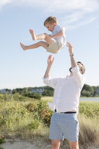 A coastal New England family session with toes in the sand and salty snuggles by the water's edge. North Shore Family Photographer. Deborah Zoe Photography.