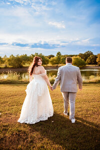 Bride and Groom walking together at The Barn At Paradise Place captured by Graceful Ray Photography in Fort Worth Texas