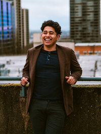 Creative portrait of an artist photographed on a rooftop.