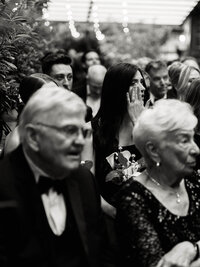 A black and white view of a wedding ceremony at Wythe Hotel of guests, preserving the atmosphere and emotion of an intentional Brooklyn celebration.