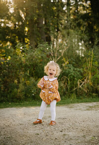 little girl smiling at camera at the park