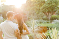 Golden hour engagement session romantic portrait of an engaged couple touching forehead to forehead in the golden light of Botanic Garden in Glencoe