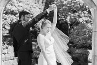 Black and white couple portrait in the garden of a Los Angeles church with soft natural light and a timeless fine art look.