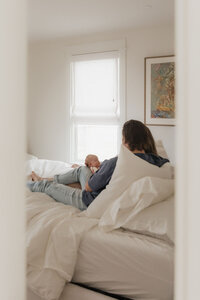 dad-newborn-bedroom-doorway-natural-light-editorial-in-home-boulder-70