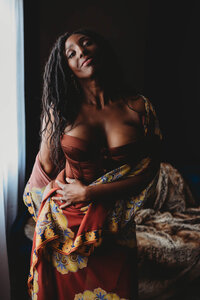 woman in skin tone lingerie with cover confident eye contact