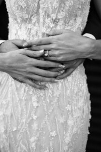 couple holds hands in wedding attire