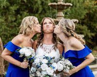 Bride and bridesmaids taking playful portraits at Azle Deer Cove captured by Graceful Ray Photography