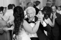 A bride dances with her family member