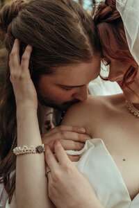 Newly married couple standing outside Airbnb cabin in North Georgia mountains for cinematic photos. Photos by Crimson Conure Photography based in Kennesaw, Georgia and Denver, Colorado