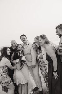 a large family comes in for a group during a beach elopement captured by shelly voss