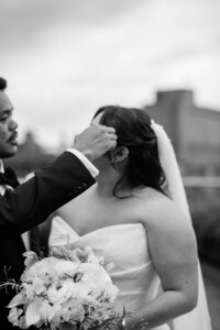 Groom moves brides hair to the side of her face
