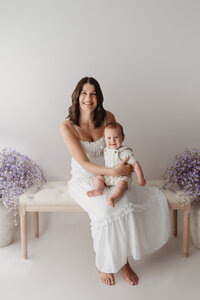 Charleston Mini Sessions - Mother embraces her baby during Mother's Day Mini Session at Holy City Babies in Charleston, SC.
