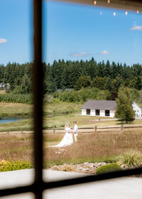 Intimate moment with bride and groom at Brightwater weddings and events in Oregon City before their wedding with the white reception barn in the background