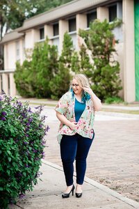 Headshot of Mahlia strolling through Orlando with tropical plants nearby