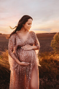 Maternity Photos in Charleston, SC -- Expectant mother poses for Maternity Portraits during Sunset on the Marsh Charleston, SC.