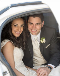 bride and groom sitting in back of limo