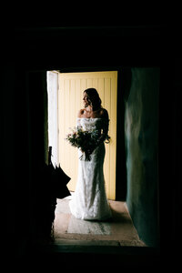 candid documentary photography bride waiting in doorway at canonteign falls colourful wedding photographer