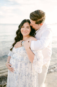 Husband kissing pregnant wife on Miami Beach, couples maternity session