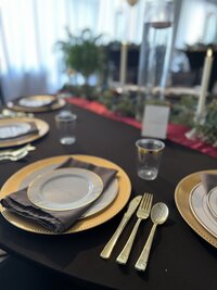 Wedding reception guest dinner setting with moody decor and elegant gold accents - Creating a romantic atmosphere