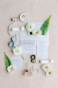 Invitations sit on a coral background.