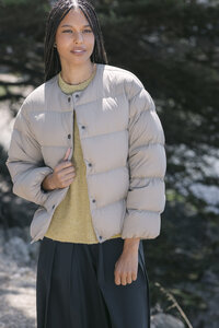 Taupe down puffer layered over a chartreuse knit, MUJI AW26 seasonal lookbook