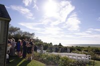 Guests mingle before wedding ceremony at private home on Nantucket.