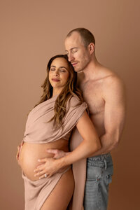 pregnant couple embracing tenderly during maternity photo session in Burbank