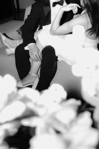 A quiet and intimate cinematic moment of the newlyweds sharing a private embrace after their wedding party, shot on film.