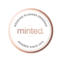 Logo of "minted" in black text within a metallic rose gold ring with an ornate texture, perfect for stress-free weddings.