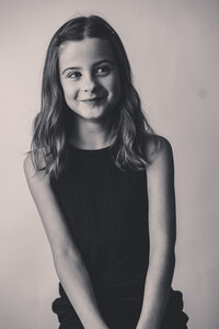 Young girl laughs off camera during Personality Portrait Session in Charleston, SC.
