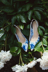 Blue floral bridal shoes surrounded by garden roses. Photography by Jessa Rose.