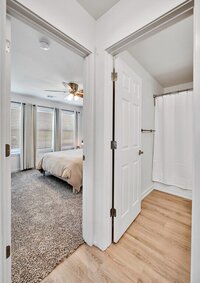 Hallway with a view of the bedroom in this 2-bedroom, 1 bathroom vacation rental home located 4 minutes from delicious Magnolia Table and 5 minutes from the beautiful Baylor campus in Waco, TX