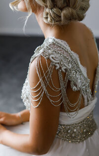 Bridal gown detail with pearl shoulder embellishments