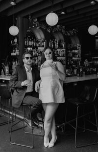 man and woman posed with sunglasses on in detroit bar