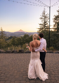 Bride and Groom watching the sunset over Mount Hood from Crag Rat Hut in Hood River Oregon