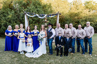 Bridal party smiling for a posed portrait at Azle Deer Cove captured by Graceful Ray Photography in Fort Worth, Texas