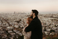 man and woman looking out over city