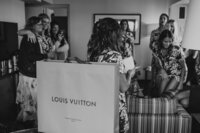 Bride gets ready with friends and opens Louis Vuitton gift bag