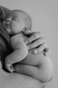 newborn-sleeping-curled-parent-arm-black-and-white-in-home-boulder-photographer-248-Edit-B&W