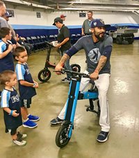 Tampa Bay Rays Sergio Romo sitting on Blue Go-Bike M2 with his kids next to him