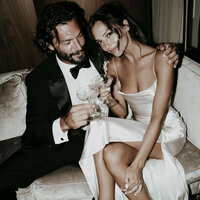 superherodesignco_34572_Newlyweds_sitting_together_on_a_velve_a9711ee0-3bd9-474c-90ca-340b4c9bd35c_0